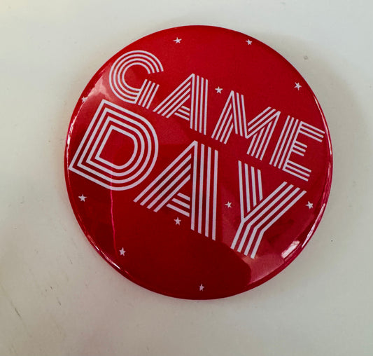 Red button with 'GAME DAY' text on a white background, red game day pins, red gameday button, college game day pins