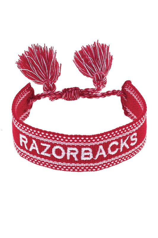 Red bracelet with tassels and 'RAZORBACKS' text on a white background