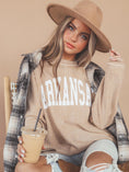Load image into Gallery viewer, A woman wearing a beige ribbed crewneck sweatshirt with 'ARKANSAS' printed in white across the chest, styled with a plaid flannel shirt, a wide-brim tan hat, and ripped jeans while holding an iced coffee. Whimsy Whoo boutique and Arkansas razorback store in Fayetteville, AR
