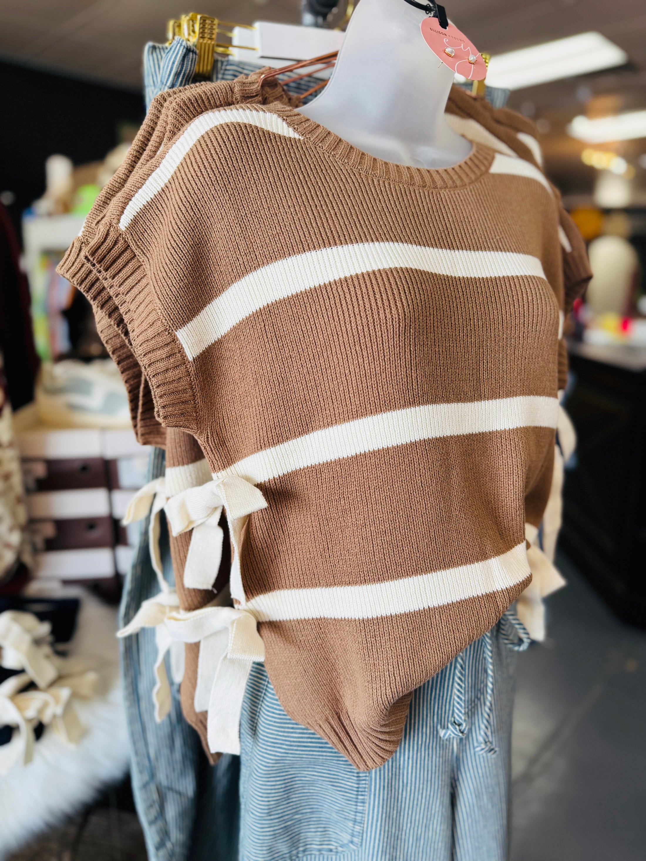 Brown and white striped sweater on a mannequin with a blurred store background, Striped sweater, sweater vest, blu pepper clothing, blu pepper sweater, sweater women, striped sweater vest, store near me fayetteville mall, boutique near me