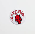 Load image into Gallery viewer, Button badge with red pig logo and 'WOOO PIG!' text on a white background, razorback gameday pins, Arkansas gameday pins, razorback gameday button, gameday buttons, tailgate buttons, red game day pins, red gameday button
