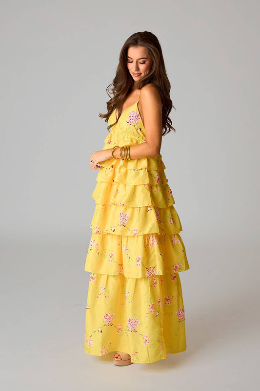 Woman wearing a yellow floral dress, wedding guest dresses in Fayetteville, ar