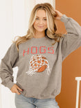 Load image into Gallery viewer, A blonde woman modeling the gray Nothing But Net Hogs Sweatshirt. This uniquely distressed, one-of-a-kind pullover is perfect for cheering on the Razorbacks at Bud Walton Arena
