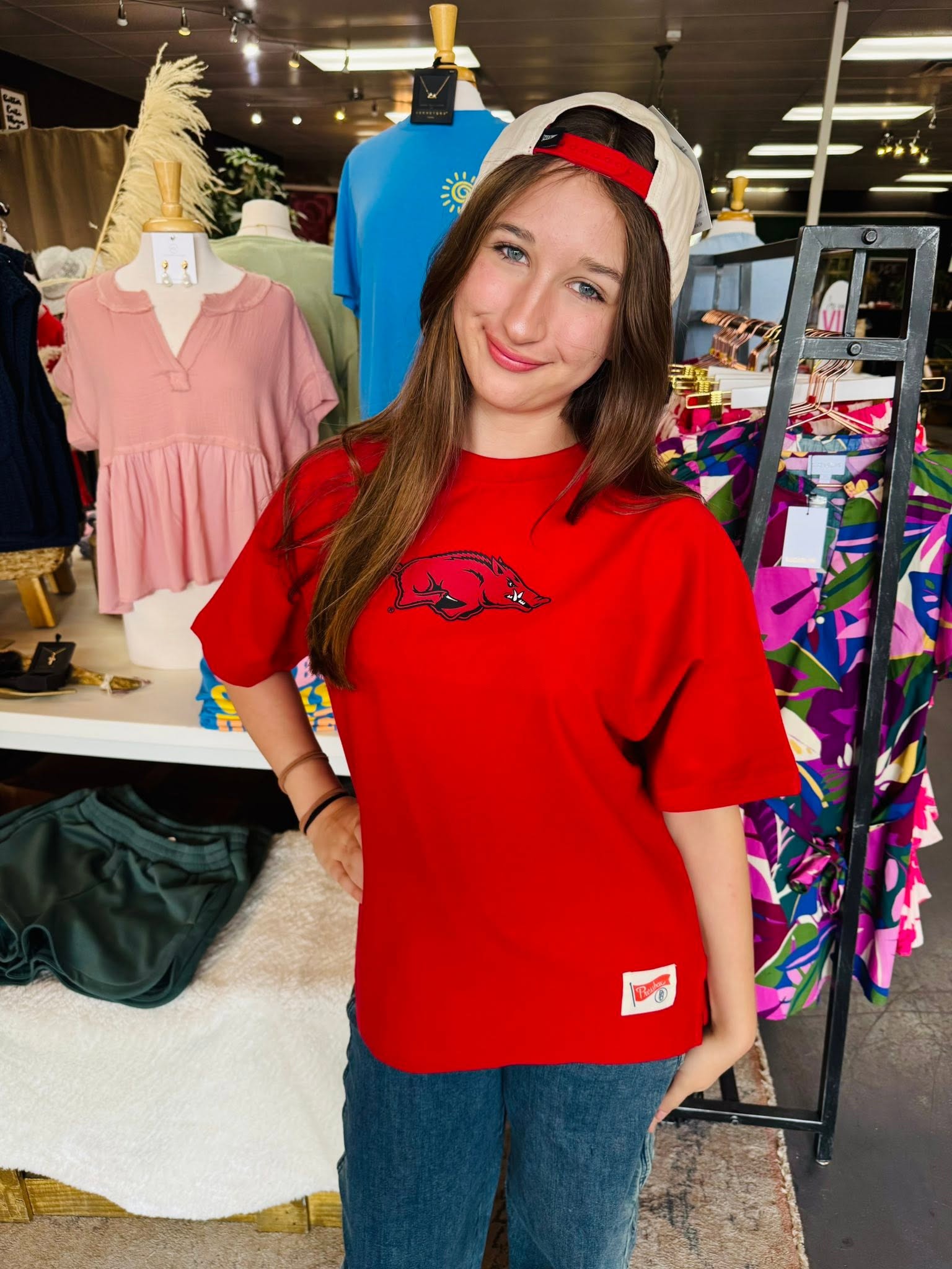 Close-up of Big Red Arkansas Razorback graphic on oversized crimson tee, women’s University of Arkansas apparel for football season and game day.