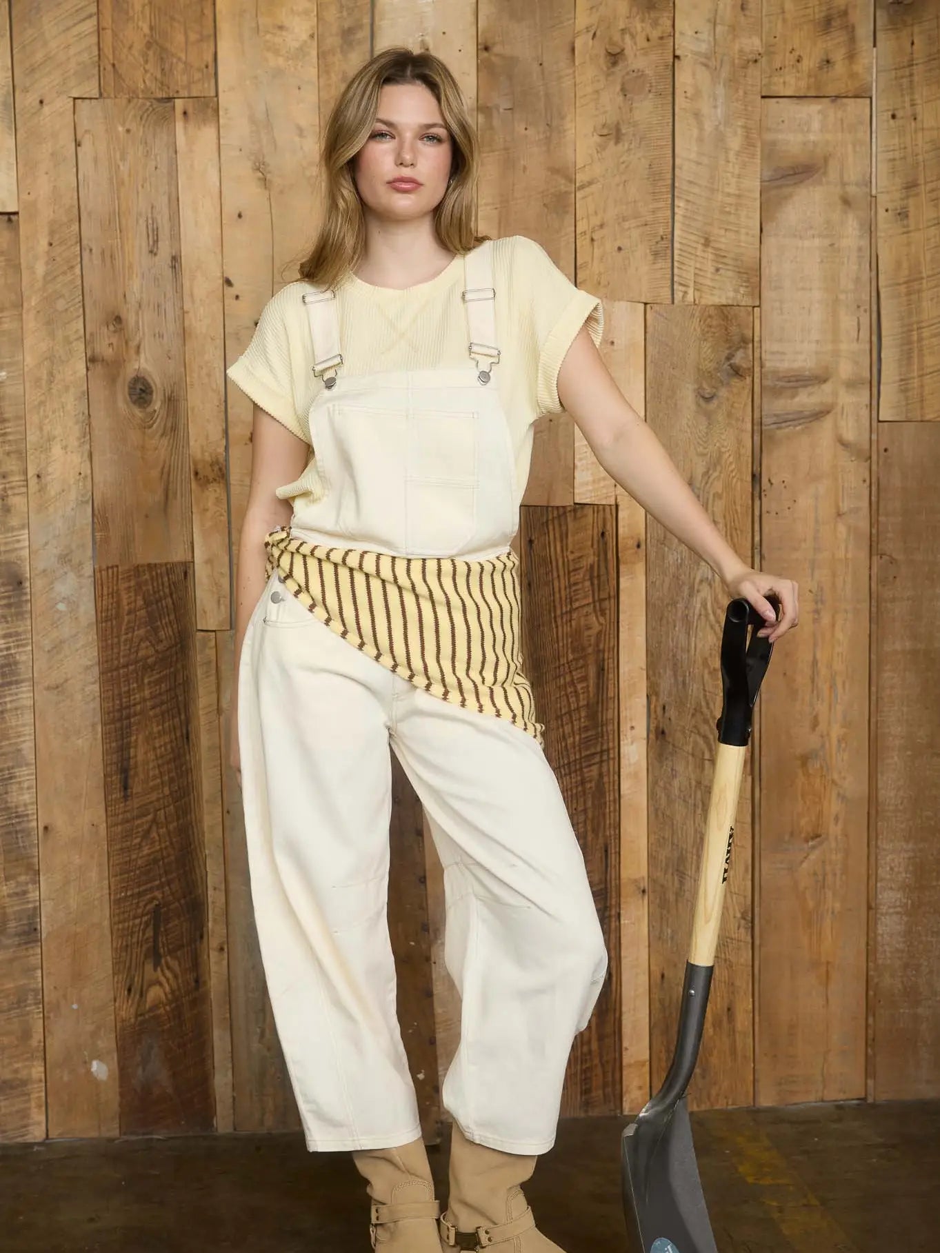 Spring Break outfit idea: Ecru barrel overalls styled with a striped sweater, perfect for Fayetteville sunny days.