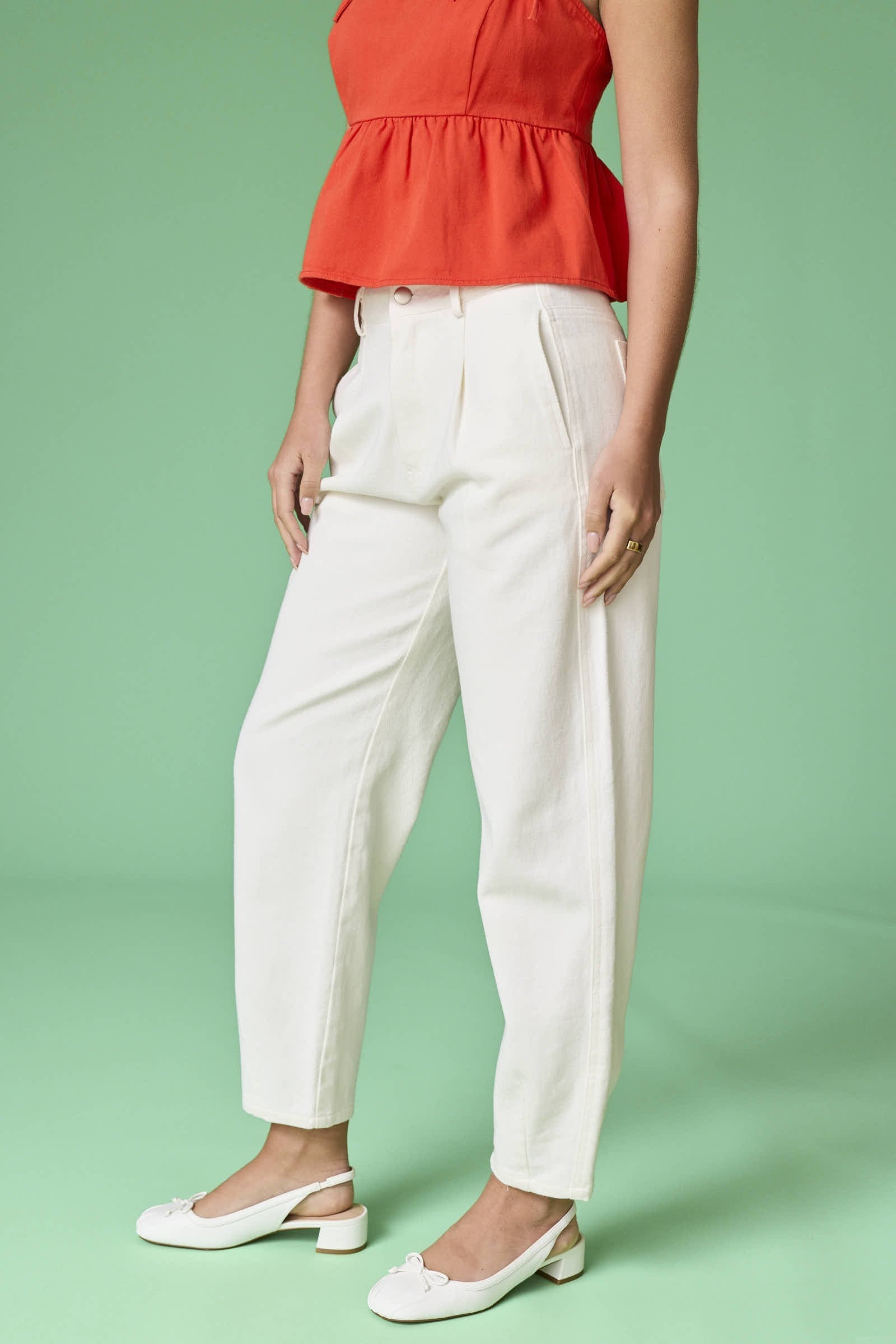 A close-up side view of the Executive Edge Barrel Pants showing the deep side pocket and crisp off-white twill material.