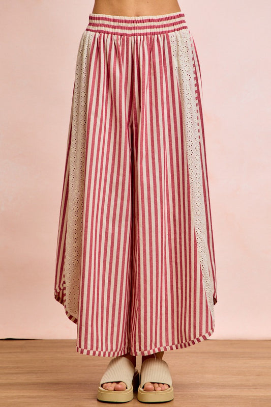 Front view of The Free Spirit Striped Barrel Pants, featuring bold red and white vertical stripes and a modern curved-leg silhouette.