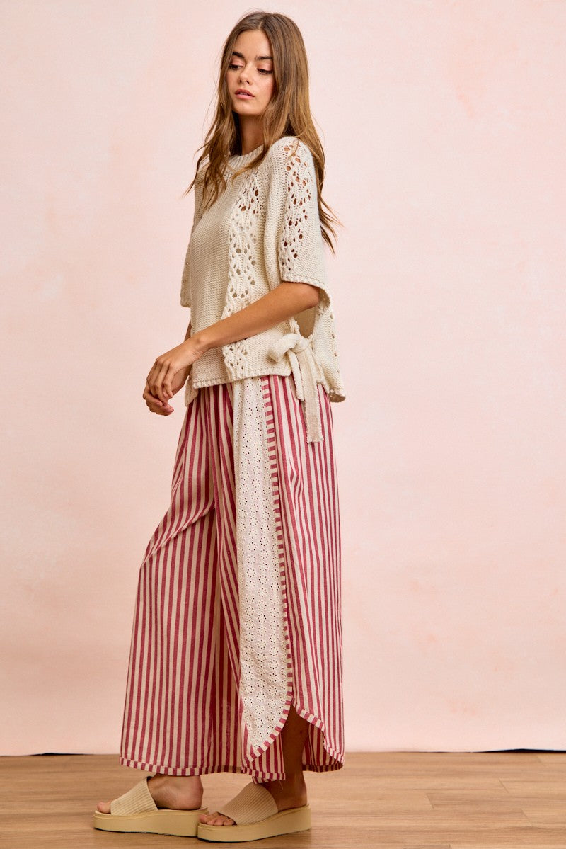 A lifestyle shot of The Free Spirit Striped Barrel Pants in red and white, showing the trendy boho curved-leg silhouette styled for a day out in Fayetteville.