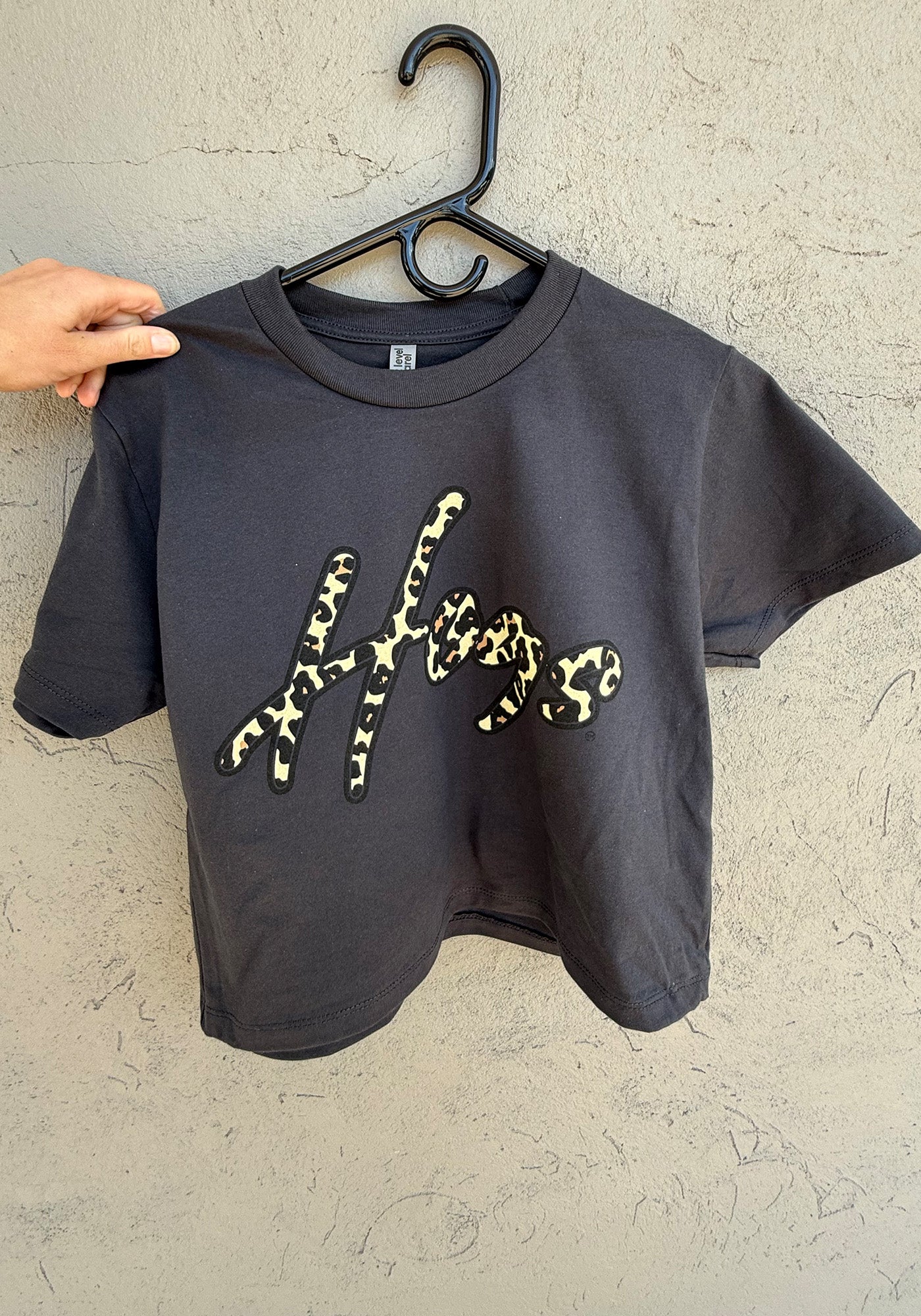 The I Spot Spirit Arkansas Hogs Tee, a charcoal cropped t-shirt featuring Hogs in a trendy cheetah print, available at Whimsy Whoo in Fayetteville, Arkansas