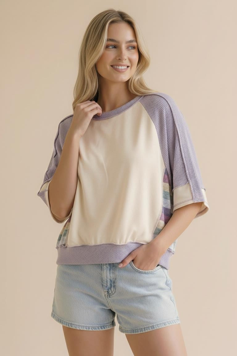 The side view of the Lavender Lane Oversized Top, showcasing the unique multi-color striped knit panels and loose raglan fit. A perfect spring transition piece for Northwest Arkansas.