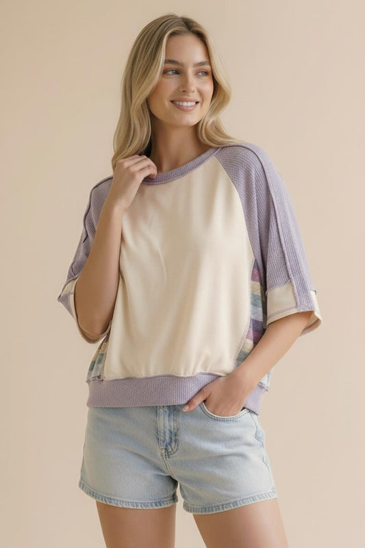 The side view of the Lavender Lane Oversized Top, showcasing the unique multi-color striped knit panels and loose raglan fit. A perfect spring transition piece for Northwest Arkansas.