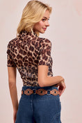 Load image into Gallery viewer, The back view of the sheer leopard print mesh mock neck top styled with denim and a western-style belt.
