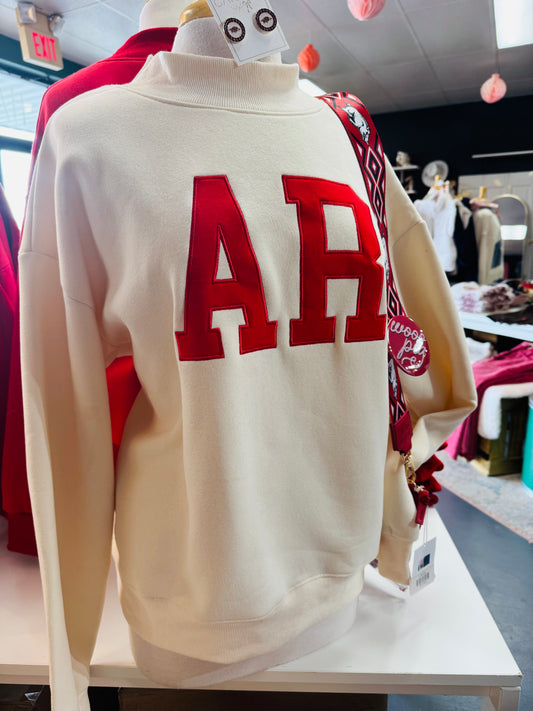 Store display at Whimsy Store featuring the AR mock neck sweatshirt styled with Razorback accessories, positioned as the best clothing store near me for gameday gear.
