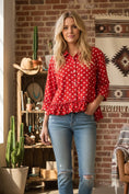Load image into Gallery viewer, Back view of the red and white polka dot peplum top highlighting the relaxed silhouette and lightweight woven drape.
