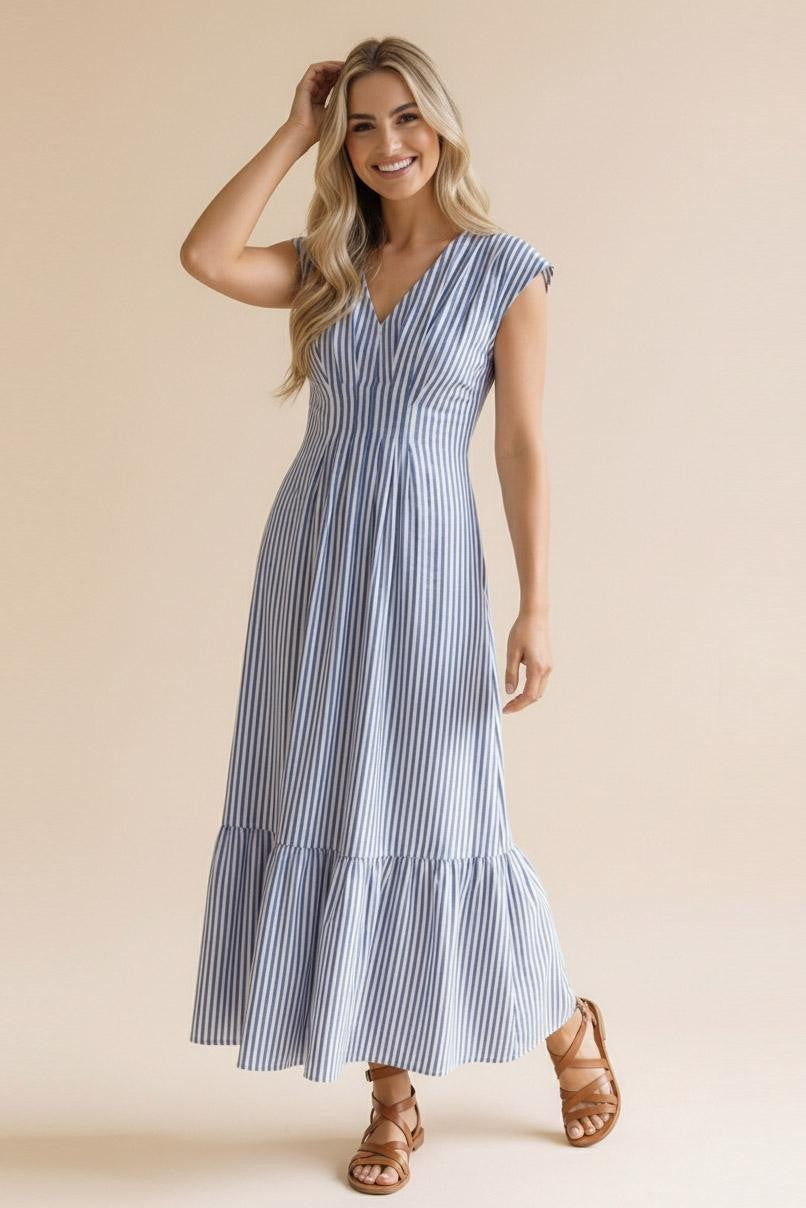 Side view of the tiered striped maxi dress from Whimsy Boutique, showcasing the breezy silhouette and comfortable fit. Perfect for a coastal getaway or a day in Fayetteville.