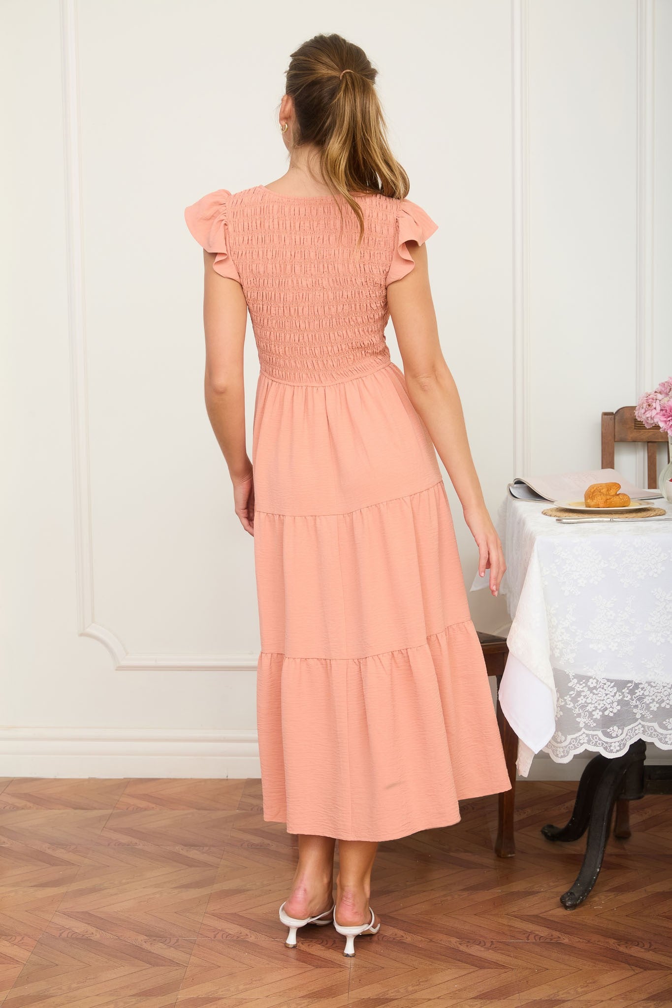 The back detail of our Peachy Keen Flutter Smocked Dress shows off a tailored, flexible fit. Shop this and more "comfy-classic" styles at Whimsy Boutique, your local Arkansas boutique.