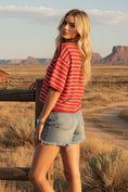 Load image into Gallery viewer, The Tailgate Chic Striped Sweater featuring bold, thick red and white stripes and a modern puff sleeve detail, styled with a straw cowboy hat.
