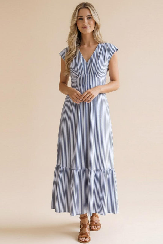 Front view of the Take me to the Seaside Striped Maxi at Whimsy Boutique. This blue and white striped tiered dress with a V-neckline is a spring essential for our Arkansas boutique shoppers.