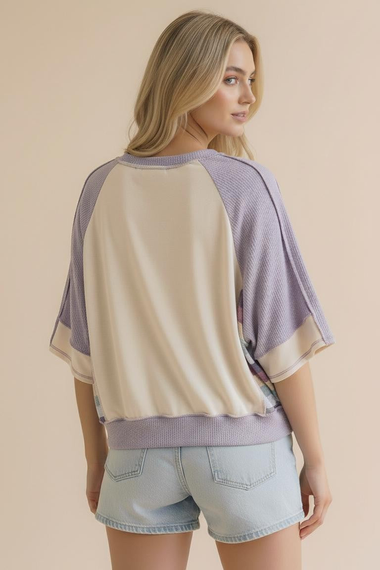 The back view of the Lavender Lane Oversized Top at Whimsy Boutique, highlighting the trendy reverse overlock out-seam stitching and comfortable waffle-textured knit.