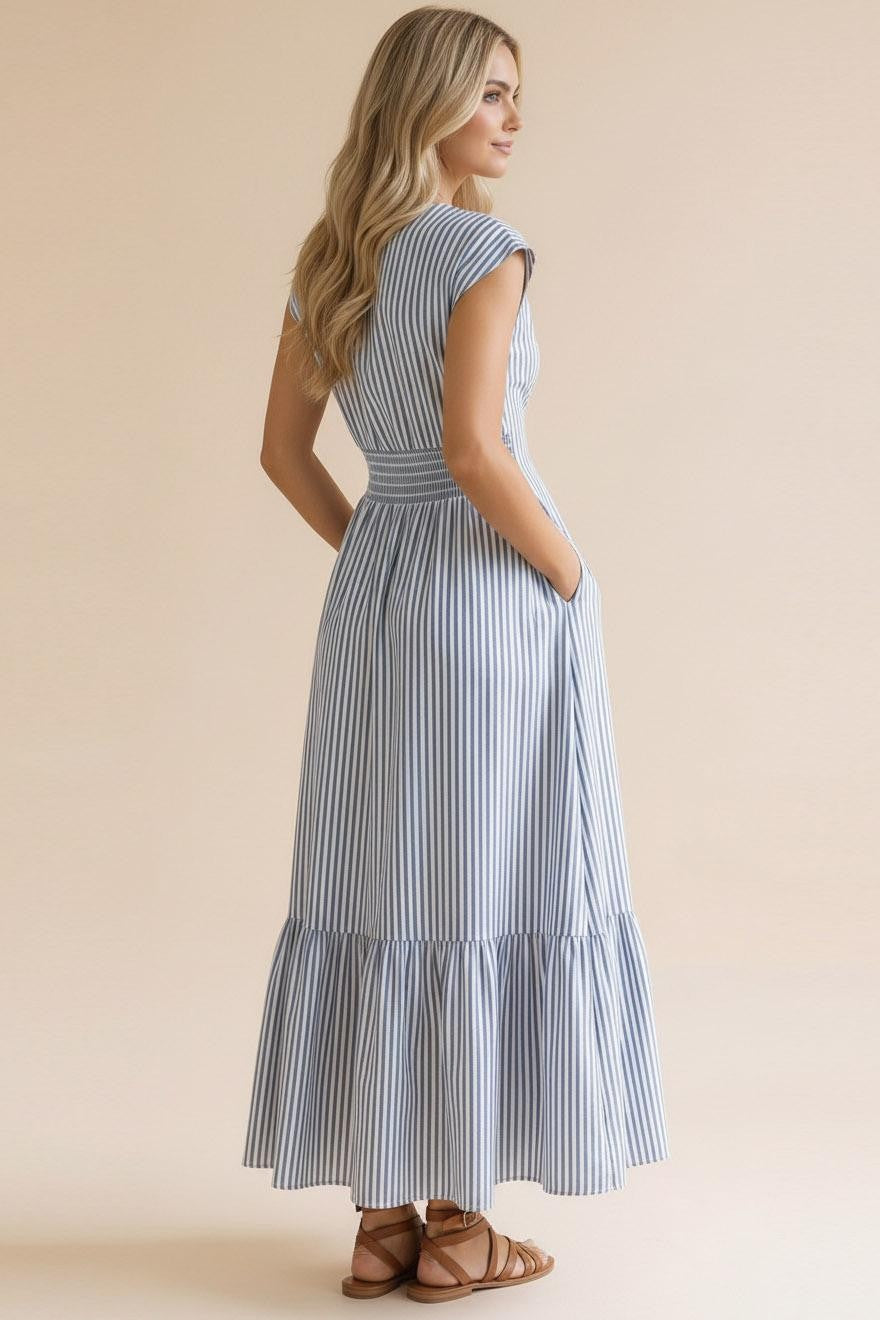 The back view of the Take me to the Seaside Striped Maxi, highlighting the high-quality fabric and flattering smocked waist. Find the latest spring arrivals at Whimsy Boutique in Fayetteville.