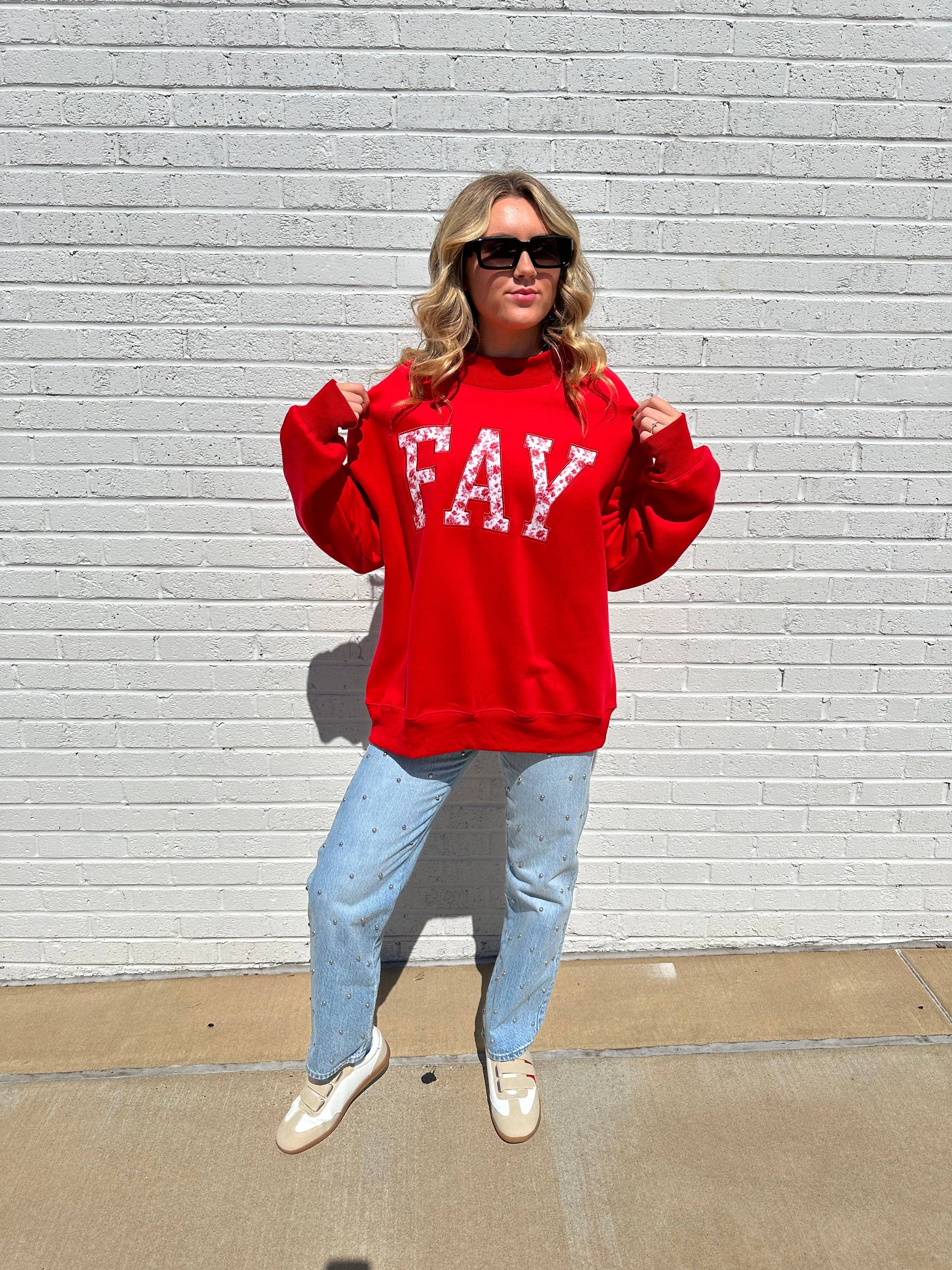 A full-length view of the Razorback Rose Arkansas Mockneck Sweatshirt in red with "FAY" lettering, styled with light wash barrel jeans at Whimsy Whoo Boutique.