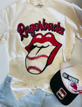 Load image into Gallery viewer, Flat lay of an ivory Rolling Stones-inspired Razorbacks baseball graphic tee with a red tongue and baseball graphic, paired with denim and an OmaHogs hat at Whimsy Whoo Boutique in Fayetteville.
