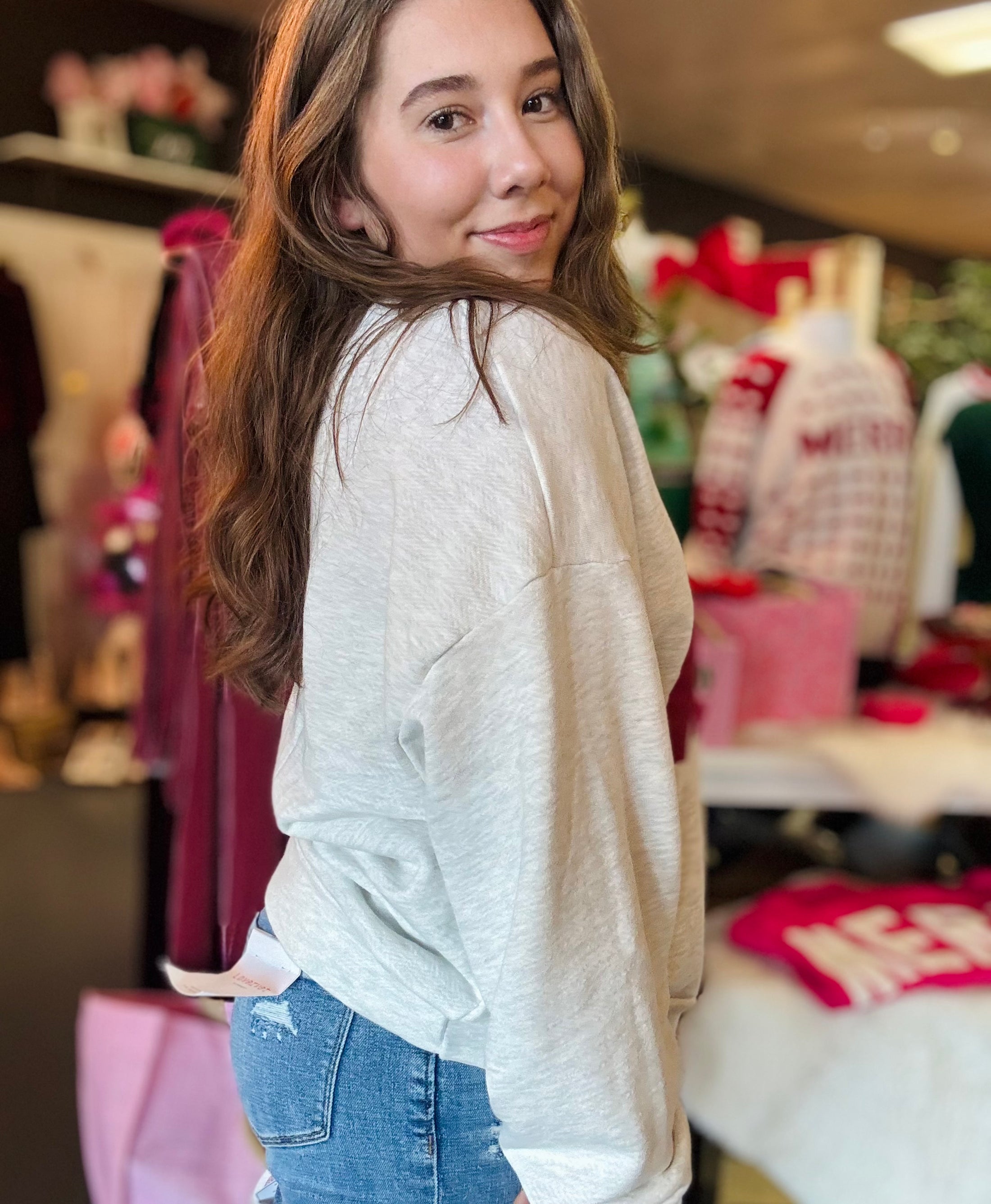 A side view of the white AR My Home sweatshirt, showing the relaxed fit and comfortable drop-shoulder style perfect for Northwest Arkansas gamedays.