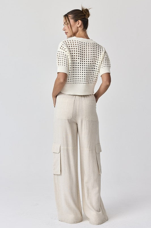 The back view of the white Oh Hey Crochet! cropped sweater, highlighting the breathable airy knit and structured ribbed hem.