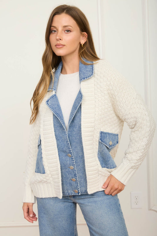 Woman wearing a white cardigan over a denim jacket with a white wall background, Fayetteville arkansas shopping near me
