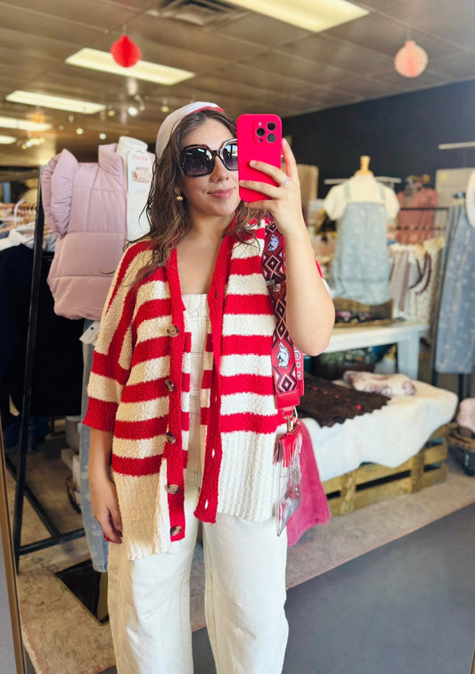Woman taking a  full-length mirror selfie at Whimsy Whoo Boutique featuring the crimson and cream striped oversized cardigan styled for an Arkansas gameday look in Fayetteville.