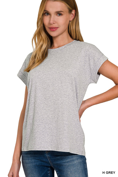 A woman wearing a heather gray basic tee with cuffed sleeves, paired with blue jeans. Zenana Basic Babe Cuffed Tee in Heather Gray featuring a classic crew neck and permanently folded cuffed short sleeves. Fayetteville arkansas store, Zenana tops, Zenana tees, Zenana clothing near me