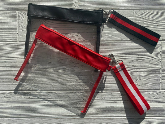 Grab & Go clear vinyl wristlet with a vibrant Razorback red and white patterned strap, perfect for Arkansas gameday.